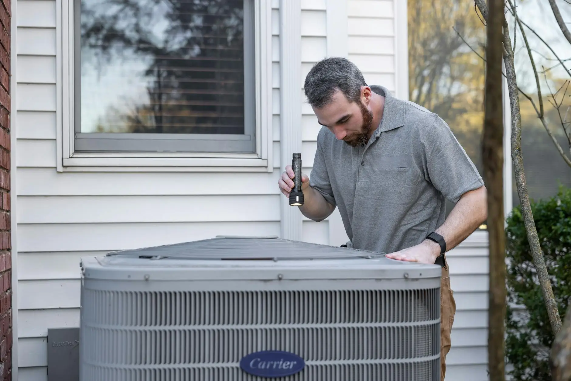 A professional-grade air mover and dehumidifier set up in a Summerville living room to prevent mold after a pipe burst.